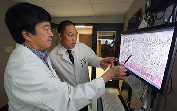 Peter Soh reviews data with his mentor Dean Naritoku