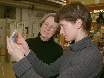 Tilghman with graduate student Ekaterina Semenova examining a biological sample